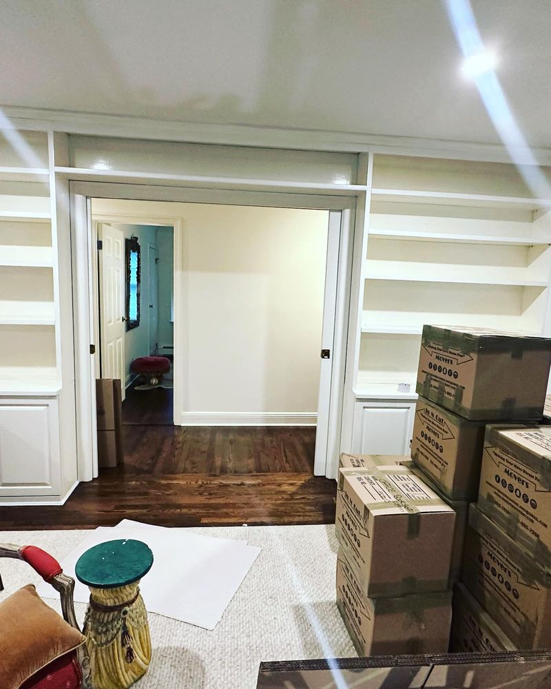In or Out Movers branded boxes stacked during a residential move