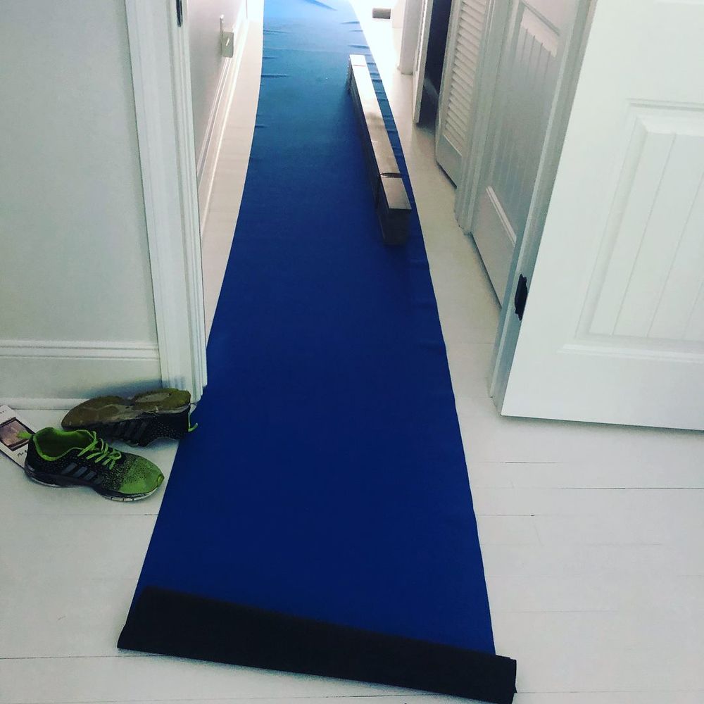 Blue floor runner protecting hardwood floors during an apartment move