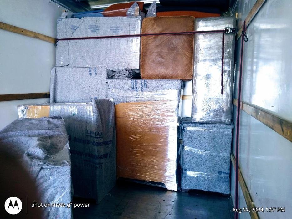In or Out Movers truck loaded with wrapped furniture for a residential move