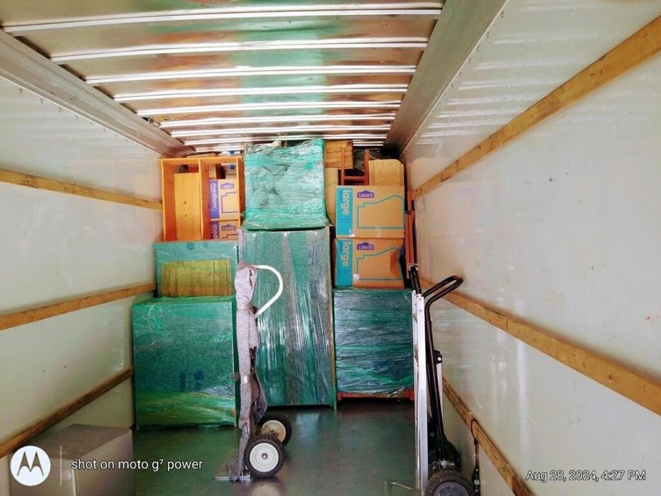 In or Out Movers truck packed and wrapped outside a Chandler apartment complex
